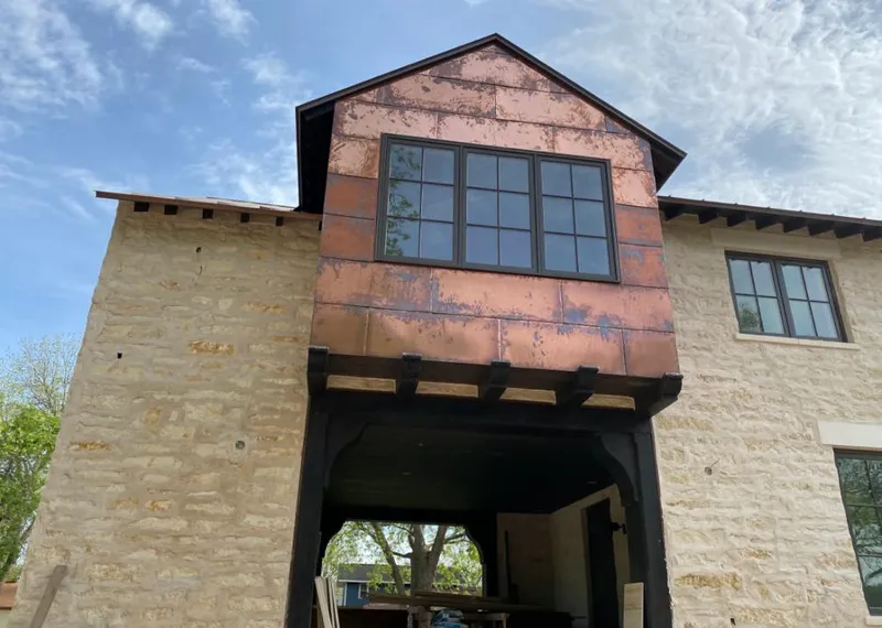 Copper metal panel facade on a stone building for Skylight Installation in West Bloomfield