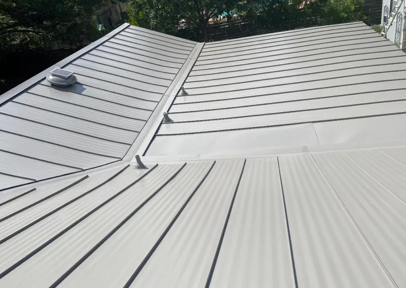 Solar attic fan installed on a metal roof for Roof Ventilation in West Bloomfield
